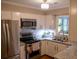 Bright kitchen featuring stainless steel appliances, white cabinetry, and granite countertops at 37 La Rue Nw Pl, Atlanta, GA 30327