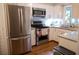 Bright kitchen featuring stainless steel appliances, white cabinetry, and granite countertops at 37 La Rue Nw Pl, Atlanta, GA 30327
