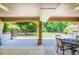 Spacious back patio with an outdoor dining set and view of the lawn at 3700 Tom Brewer Rd, Loganville, GA 30052