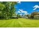Large, green backyard featuring a carport and additional buildings at 3700 Tom Brewer Rd, Loganville, GA 30052