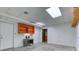 Unfinished basement featuring tile flooring, white walls, and a storage unit at 3700 Tom Brewer Rd, Loganville, GA 30052