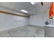 Unfinished basement featuring tile flooring, white walls, and a storage unit at 3700 Tom Brewer Rd, Loganville, GA 30052