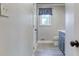 Bathroom with a blue vanity, white countertops, wood look tile floor and a glass shower door at 3700 Tom Brewer Rd, Loganville, GA 30052