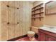 Bathroom featuring patterned wallpaper, floating shelves, and a single sink vanity at 3700 Tom Brewer Rd, Loganville, GA 30052