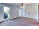 Bedroom with carpet, windows, a ceiling fan, double doors, and white trim at 3700 Tom Brewer Rd, Loganville, GA 30052