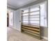 Bedroom with carpet, window, door, and custom built-in shelving at 3700 Tom Brewer Rd, Loganville, GA 30052