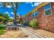 Exterior showcasing brick facade, well-maintained landscaping, and backyard access at 3700 Tom Brewer Rd, Loganville, GA 30052