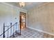Foyer with decorative tile flooring and staircase leading to a spacious living area at 3700 Tom Brewer Rd, Loganville, GA 30052
