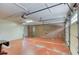 Spacious garage with red floor and an inviting side entry door at 3700 Tom Brewer Rd, Loganville, GA 30052