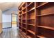 Hallway with built in wooden bookshelves and patterned tile flooring at 3700 Tom Brewer Rd, Loganville, GA 30052