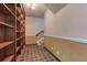 Hallway with built in wooden bookshelves, patterned tile flooring, and staircase at 3700 Tom Brewer Rd, Loganville, GA 30052