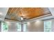 Main bedroom with a wood paneled tray ceiling, recessed lighting, and many windows at 3700 Tom Brewer Rd, Loganville, GA 30052