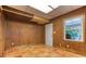 Room with wood paneled walls, tile flooring, and a window with a view to the backyard at 3700 Tom Brewer Rd, Loganville, GA 30052