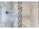 Modern shower featuring marble tiling and a stylish vertical accent stripe at 3700 Tom Brewer Rd, Loganville, GA 30052