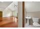 A simple bathroom with a pedestal sink and a toilet located just off the main living area at 70 Juliana Dr, Ellenwood, GA 30294