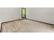 A bedroom with a high ceiling and neutral carpet flooring looking out to trees at 70 Juliana Dr, Ellenwood, GA 30294