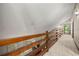Hallway featuring carpet, wooden handrail, and high ceilings at 70 Juliana Dr, Ellenwood, GA 30294