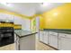 Kitchen with white cabinets, island, and black appliances at 70 Juliana Dr, Ellenwood, GA 30294