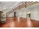 A spacious living room with high ceilings, hardwood floors, stairs to an open loft, and a stone fireplace at 70 Juliana Dr, Ellenwood, GA 30294
