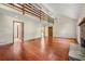 A spacious living room with high ceilings, hardwood floors, stairs to an open loft, and a stone fireplace at 70 Juliana Dr, Ellenwood, GA 30294