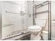 Updated bathroom features a glass-enclosed shower with a built-in bench at 1055 Avalon Dr, Lawrenceville, GA 30044