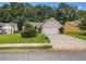 Traditional home features a well-manicured lawn, mature trees, and a private driveway at 1055 Avalon Dr, Lawrenceville, GA 30044