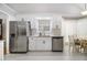 Modern kitchen features stainless steel appliances, white cabinets, and granite countertops at 1055 Avalon Dr, Lawrenceville, GA 30044