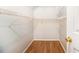 Walk-in closet with custom shelving and hardwood floors for ample storage at 1055 Avalon Dr, Lawrenceville, GA 30044
