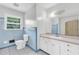 Classic bathroom with blue tiled walls, white fixtures, and a vanity at 1189 E Fayetteville Rd, Riverdale, GA 30296