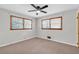 Sunlit bedroom featuring two windows and neutral walls and flooring at 1189 E Fayetteville Rd, Riverdale, GA 30296
