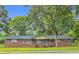 Charming brick ranch-style home with well-maintained lawn and mature trees at 1189 E Fayetteville Rd, Riverdale, GA 30296