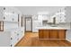 Bright kitchen with white cabinets, wood detailing, and modern appliances at 1189 E Fayetteville Rd, Riverdale, GA 30296