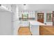 Functional kitchen with white cabinets, laminate countertops, and appliances at 1189 E Fayetteville Rd, Riverdale, GA 30296