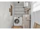 The functional laundry room features modern appliances and extra shelving at 1189 E Fayetteville Rd, Riverdale, GA 30296