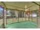 Back porch with artificial grass flooring, ceiling fan, and orange curtains at 1189 E Fayetteville Rd, Riverdale, GA 30296