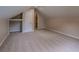 Finished attic with neutral paint and plush carpeting and a doorway to another room at 1555 New Ne St, Atlanta, GA 30307