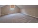 Spacious finished attic with neutral paint and plush carpeting throughout at 1555 New Ne St, Atlanta, GA 30307