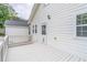 Charming back porch that features white wood, a door to the house, and an outdoor light fixture at 1555 New Ne St, Atlanta, GA 30307