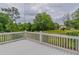 Charming back yard featuring a white deck overlooking a lush lawn with mature trees at 1555 New Ne St, Atlanta, GA 30307