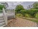 Backyard with deck, brick patio, and manicured bushes at 1555 New Ne St, Atlanta, GA 30307
