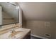 Cozy bathroom featuring a vanity with a beige countertop, a black framed mirror, and vinyl flooring at 1555 New Ne St, Atlanta, GA 30307