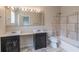 Bathroom with a large vanity, ample lighting, and a shower-tub combination with decorative tile at 1555 New Ne St, Atlanta, GA 30307