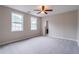 Bright and airy bedroom featuring neutral walls, plush carpet, and natural light from two windows at 1555 New Ne St, Atlanta, GA 30307