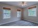 Cozy bedroom featuring hardwood floors and natural light from multiple windows at 1555 New Ne St, Atlanta, GA 30307