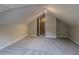 Bright bonus room featuring neutral paint, plush carpeting, unique sloped ceilings, and natural light at 1555 New Ne St, Atlanta, GA 30307