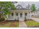 Charming home with a welcoming front porch, landscaped yard, and inviting curb appeal at 1555 New Ne St, Atlanta, GA 30307