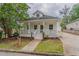 Charming home with a welcoming front porch, landscaped yard, and inviting curb appeal at 1555 New Ne St, Atlanta, GA 30307