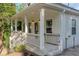 Quaint home featuring a covered porch with classic white columns, railings, and steps at 1555 New Ne St, Atlanta, GA 30307