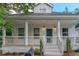 Charming home with a welcoming white front porch, columns, and a freshly landscaped yard at 1555 New Ne St, Atlanta, GA 30307