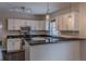 Modern kitchen featuring stainless steel appliances, granite countertops, and ample cabinet space at 1555 New Ne St, Atlanta, GA 30307